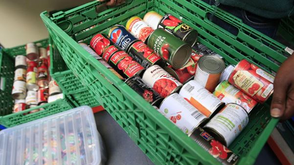 Food bank crate filled with tins of food