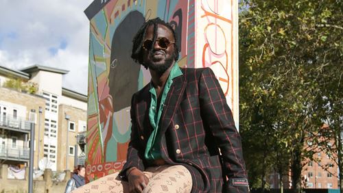 Artist, Adébayo Bolaji, sat on his art sculpture 'The People’s Throne'