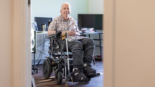 A man sat in an electronic wheelchair