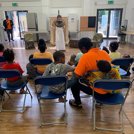 Children and their parents watching a live performance