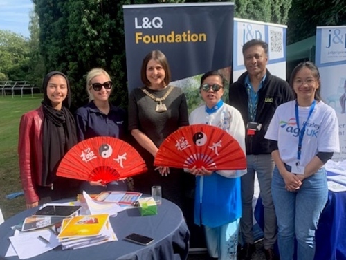 Group of people outside by a L&Q Foundation banner