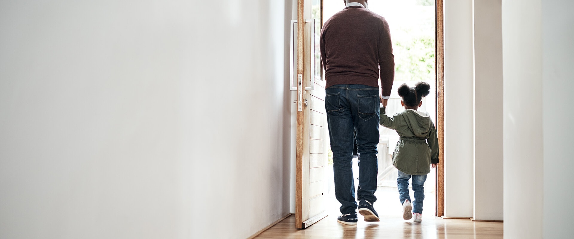 Father and child walking out the front door